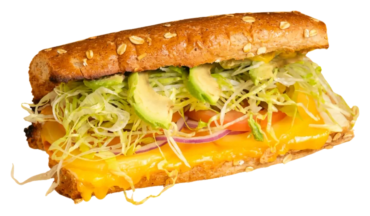 Veggie Delight sandwich loaded with fresh spinach, cucumber, tomatoes, and avocado